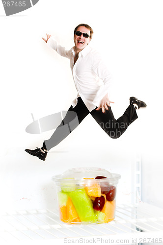 Image of man jumping over fruit cup