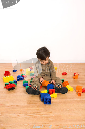 Image of baby playing on laminated flooring