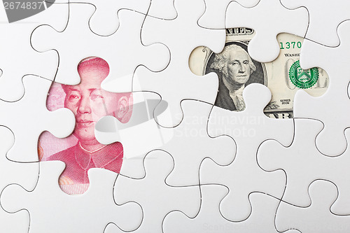 Image of US and chinese yuan with white puzzle for exchange rate concept