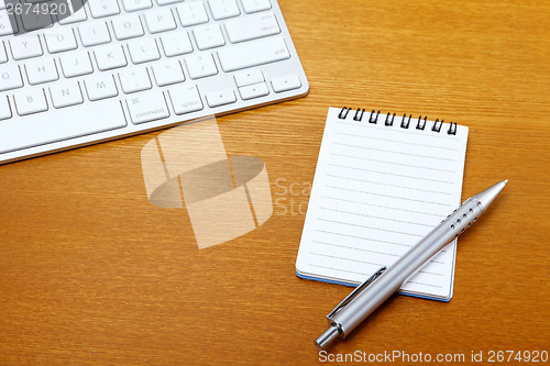 Image of Notepad and computer keyboard