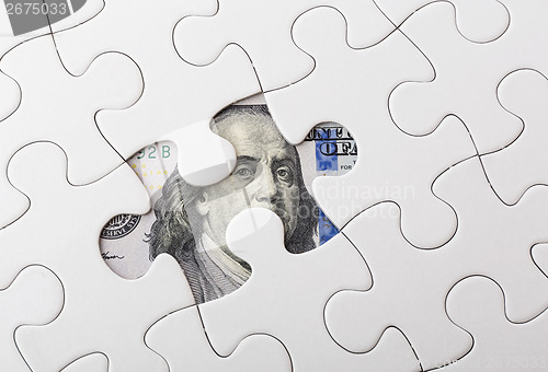 Image of White puzzle with American dollar