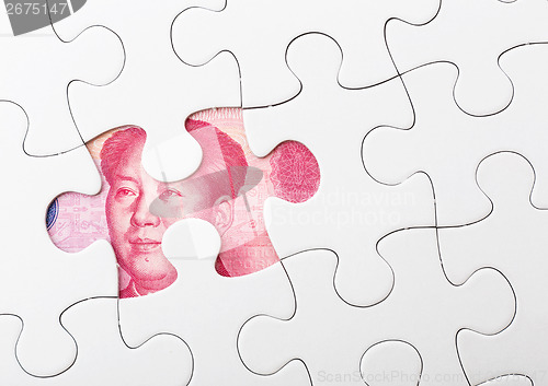 Image of White puzzle and chinese banknote