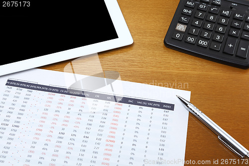 Image of Data analysis with tablet and calculator