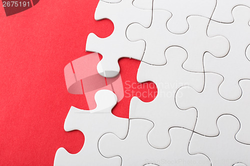 Image of White puzzle on red background