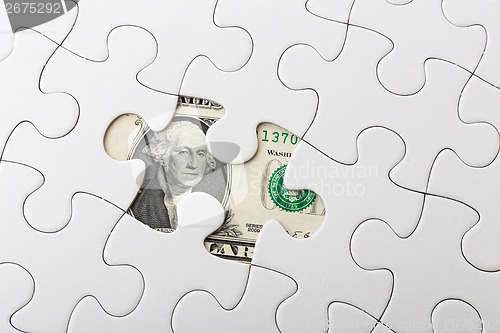 Image of US dollar banknote and puzzle 