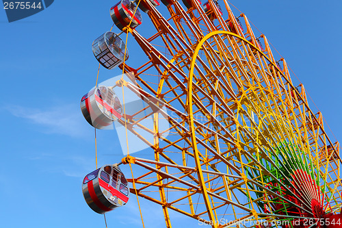 Image of Ferris wheel with blue sky