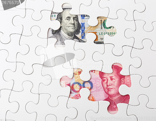 Image of White puzzle with US and chinese banknote