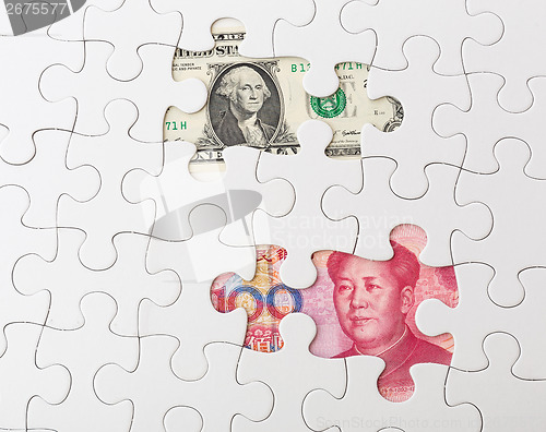 Image of White puzzle with American dollar and chinese yuan
