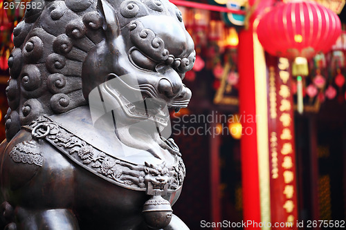 Image of Lion statue in front of chinese temple