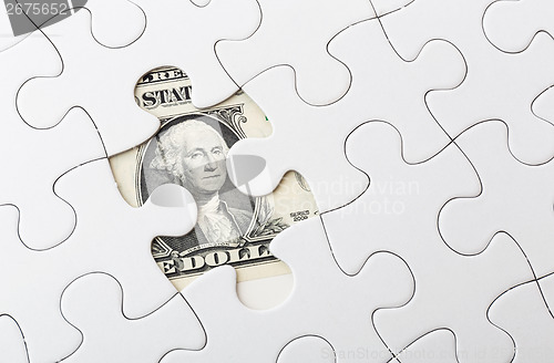 Image of Dollar bill and puzzle piece