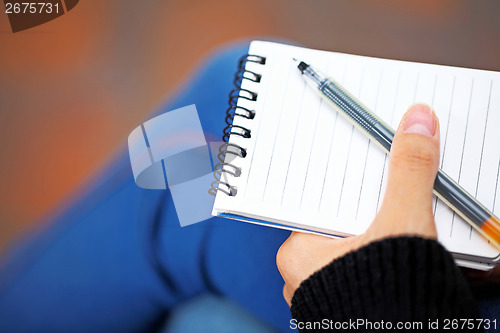 Image of Notepad hold by hand