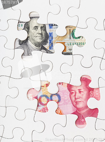 Image of US dollar and chinese yuan with white puzzle