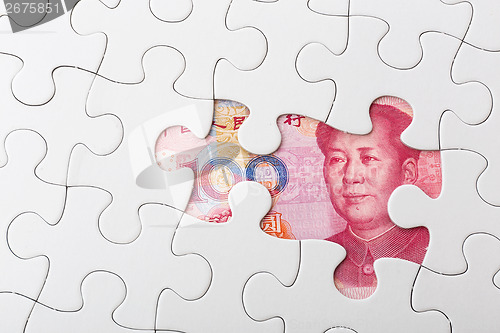 Image of Chinese yuan and puzzle piece