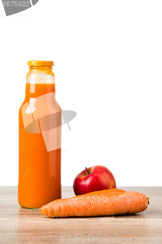Image of Bottle with carrots juice and an apple