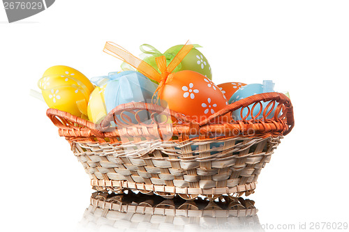 Image of color easter eggs in basket isolated on white