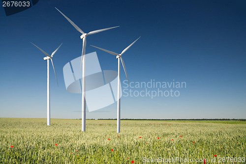 Image of Wind generator turbine on spring landscape