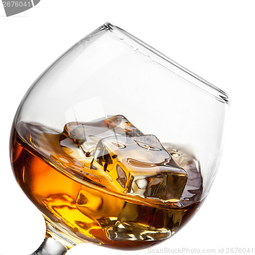 Image of Splash of whiskey with ice in glass isolated on white background