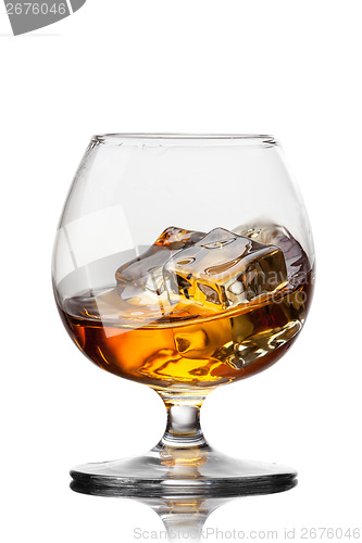 Image of Splash of whiskey with ice in glass isolated on white background