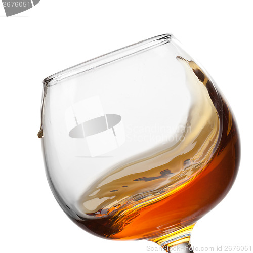 Image of Splash of cognac in glass isolated on white background