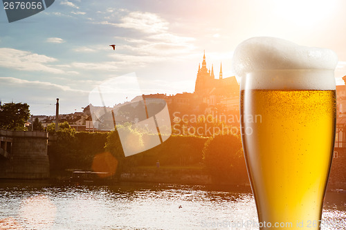 Image of Glass of beer against view of the St. Vitus Cathedral in Prague