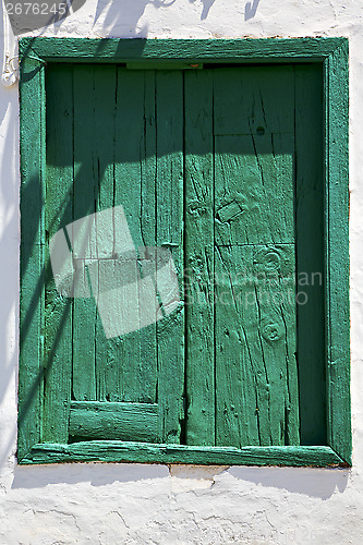 Image of spain green wood   window in a white wall arrecife  