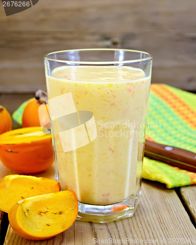 Image of Milkshake with persimmons in glass on board