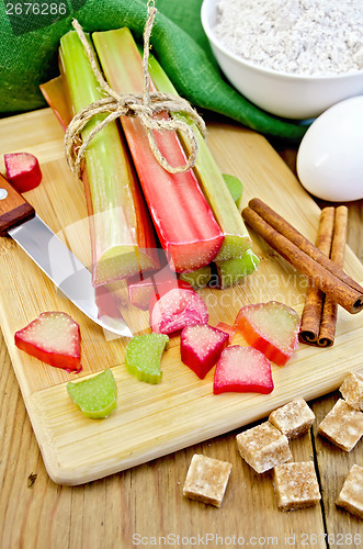 Image of Rhubarb with sugar and knife on board