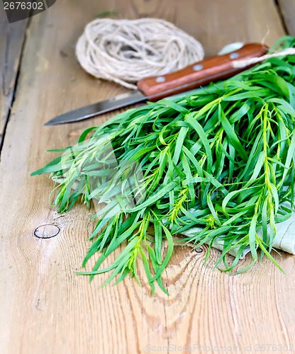 Image of Tarragon with knife and napkin on board