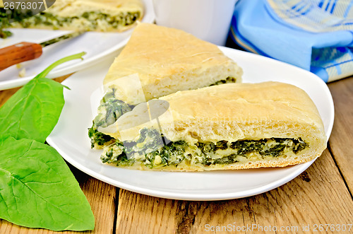 Image of Pie spinach and cheese on board with knife