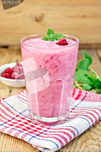 Image of Milkshake with raspberries on board