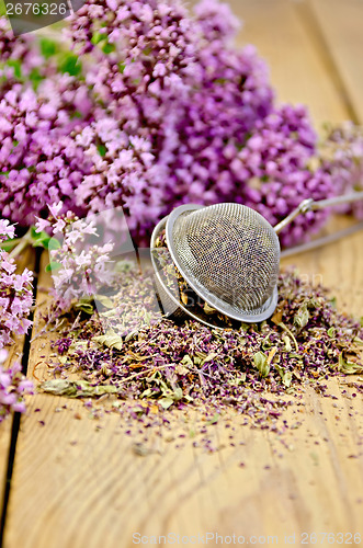 Image of Herbal tea from dry and fresh oregano with strainer