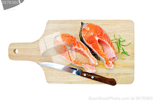 Image of Trout on the board with a knife and rosemary