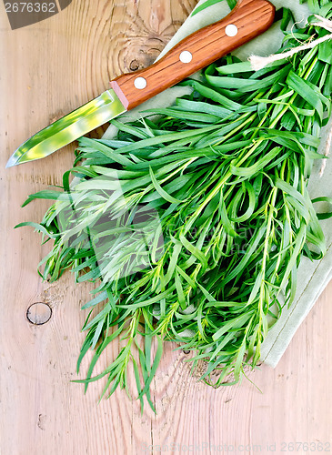 Image of Tarragon with a knife on board