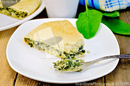 Image of Pie spinach and cheese with fork on board