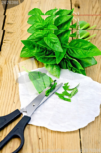 Image of Basil green with scissors on board