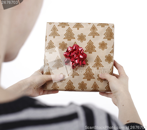 Image of Young woman holding a present