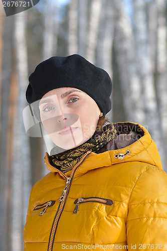 Image of Woman in black beret and a yellow jacket.