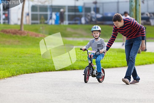 Image of family biking