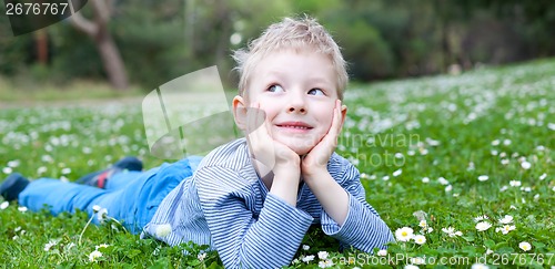 Image of child lying at grass