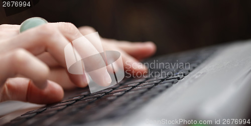 Image of Young woman working on laptop