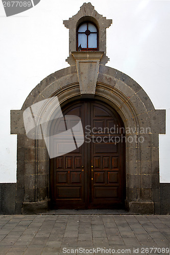 Image of lanzarote  spain canarias brass brown knocker in a   closed wood