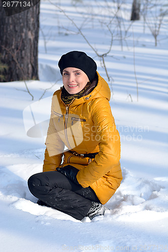 Image of Portrait of a woman sitting in the snow
