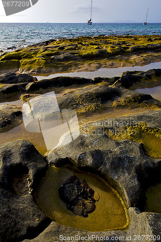 Image of boat   lanzarote    coastline rock beach     summer 