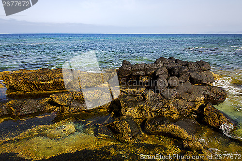 Image of in lanzarote froth coastline  spain pond  rock stone sky cloud  