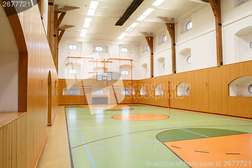Image of Empty interior of public gym with basketball court