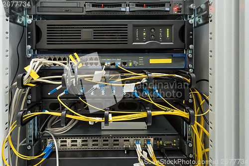 Image of fiber optic datacenter with media converters and optical cables 