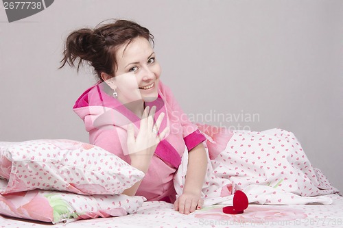 Image of girl on bed gave a ring