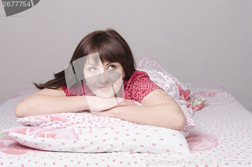 Image of girl dreams lying in bed