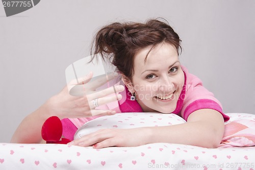 Image of The girl wore a gift ring, lying in bed