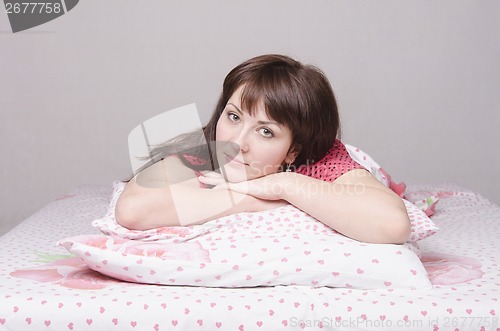 Image of Thoughtful girl lying in bed